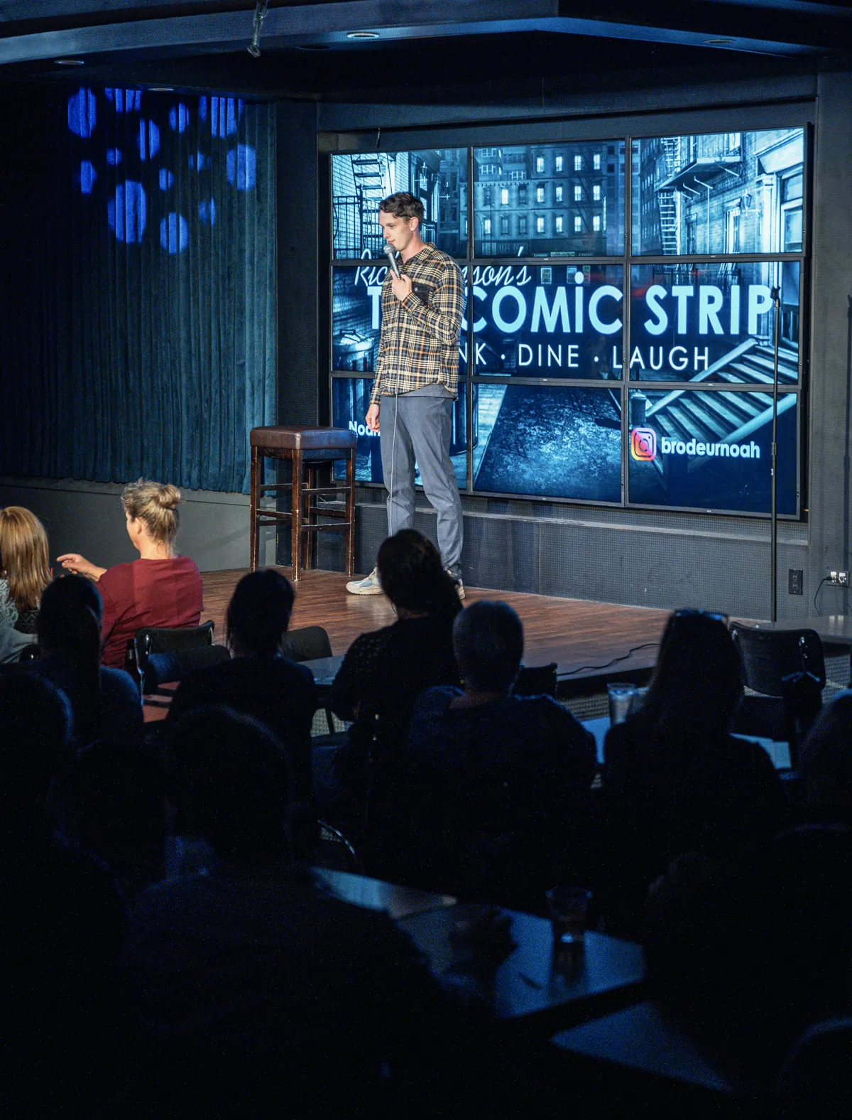 Comedian performing on stage at The Comic Strip
