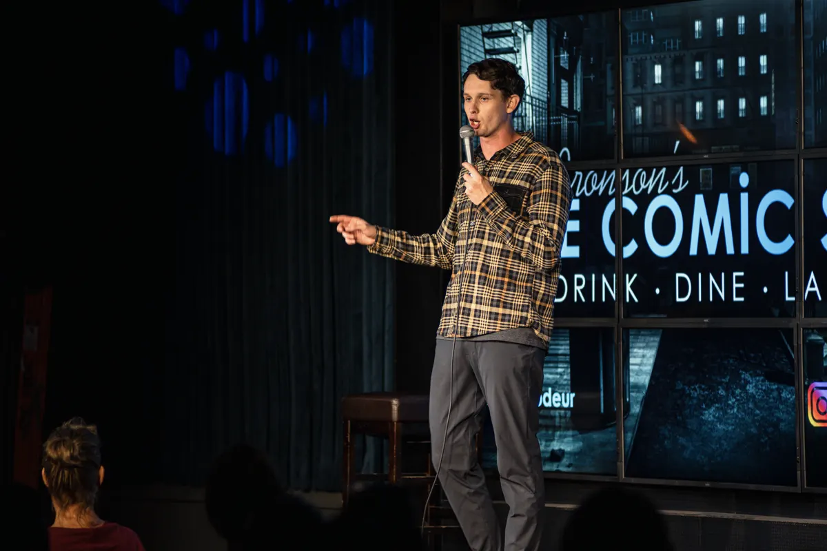 Comedian gesturing on stage